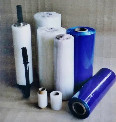 Welpac packaging company A variety of rolls of plastic film from Welpac Packaging Company on a table.