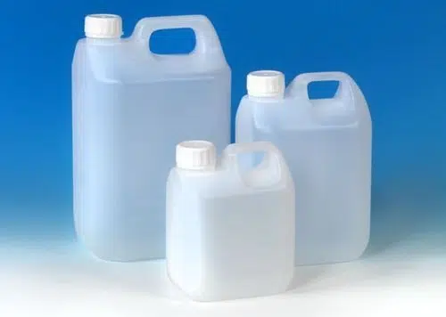 Welpac packaging company Three plastic jugs from the Welpac Packaging Company on a blue background.