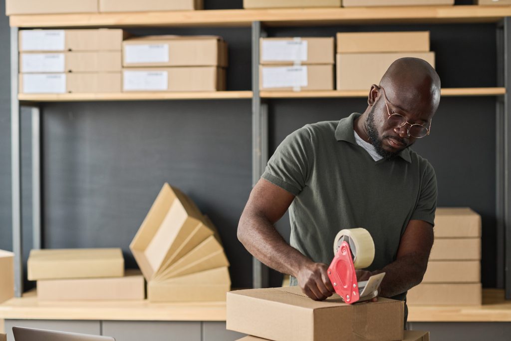 warehouse worker packing parcel for delivery 2023 11 27 04 59 45 utc